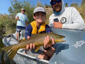 kid catches brown trout